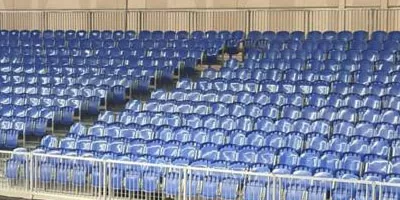 Demountable metal grandstands with blue seats at Dubai International Badminton World Cup, modular sports event seating