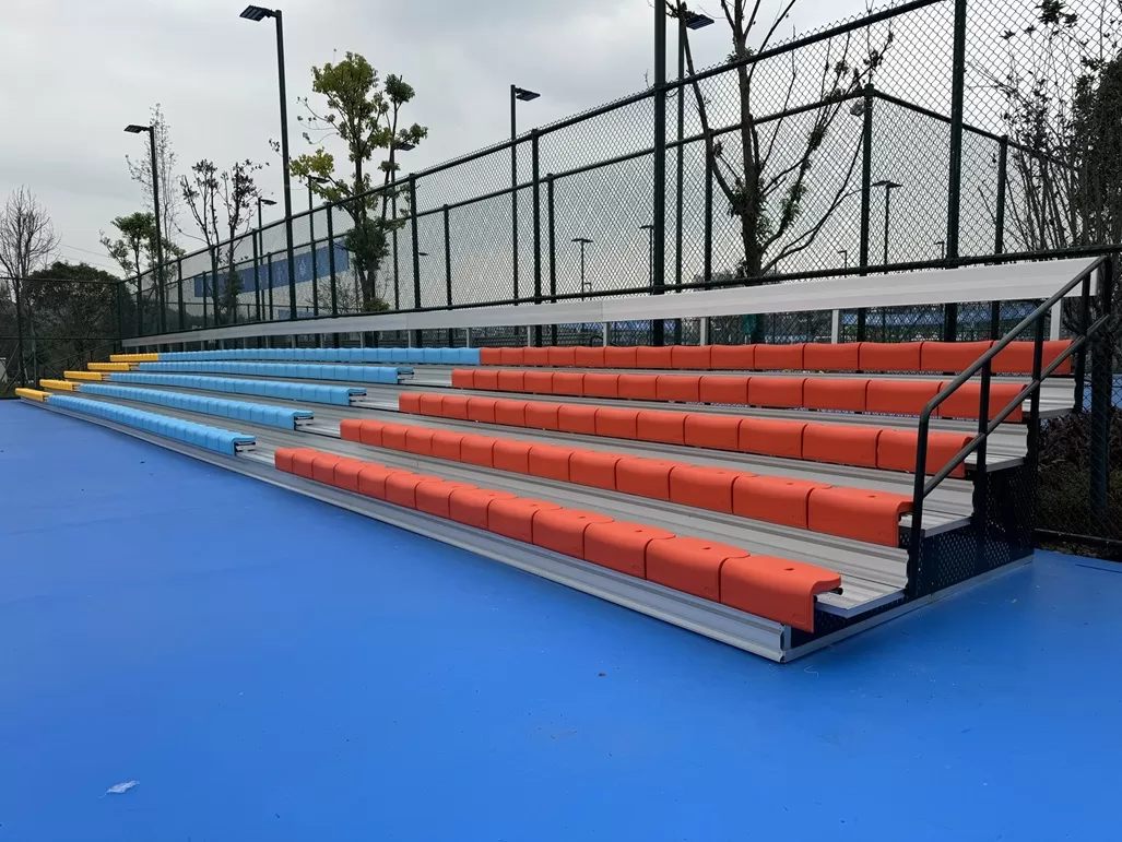 Durable, modular outdoor metal bleachers for sports courts. Weather - proof, vibrant, and easy to install—ideal for community venues and schools