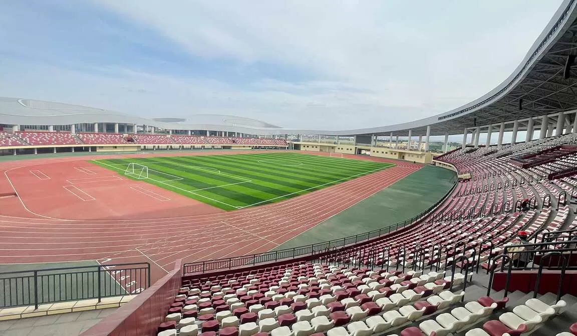 Shawan Sports Center Xinjiang, Spoon-M Mid-back Blow-molded Seats, Red and White Color Scheme, Full View of Athletics Track and Football Field