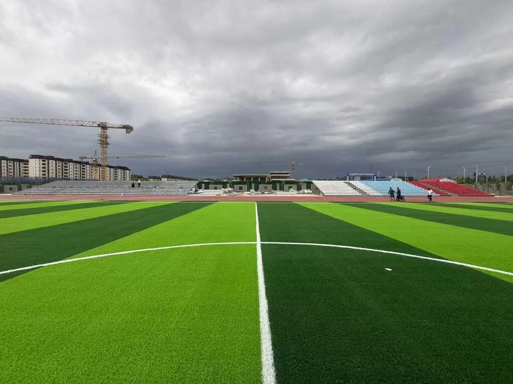 School football field with modular grandstand under construction in Ili, Xinjiang